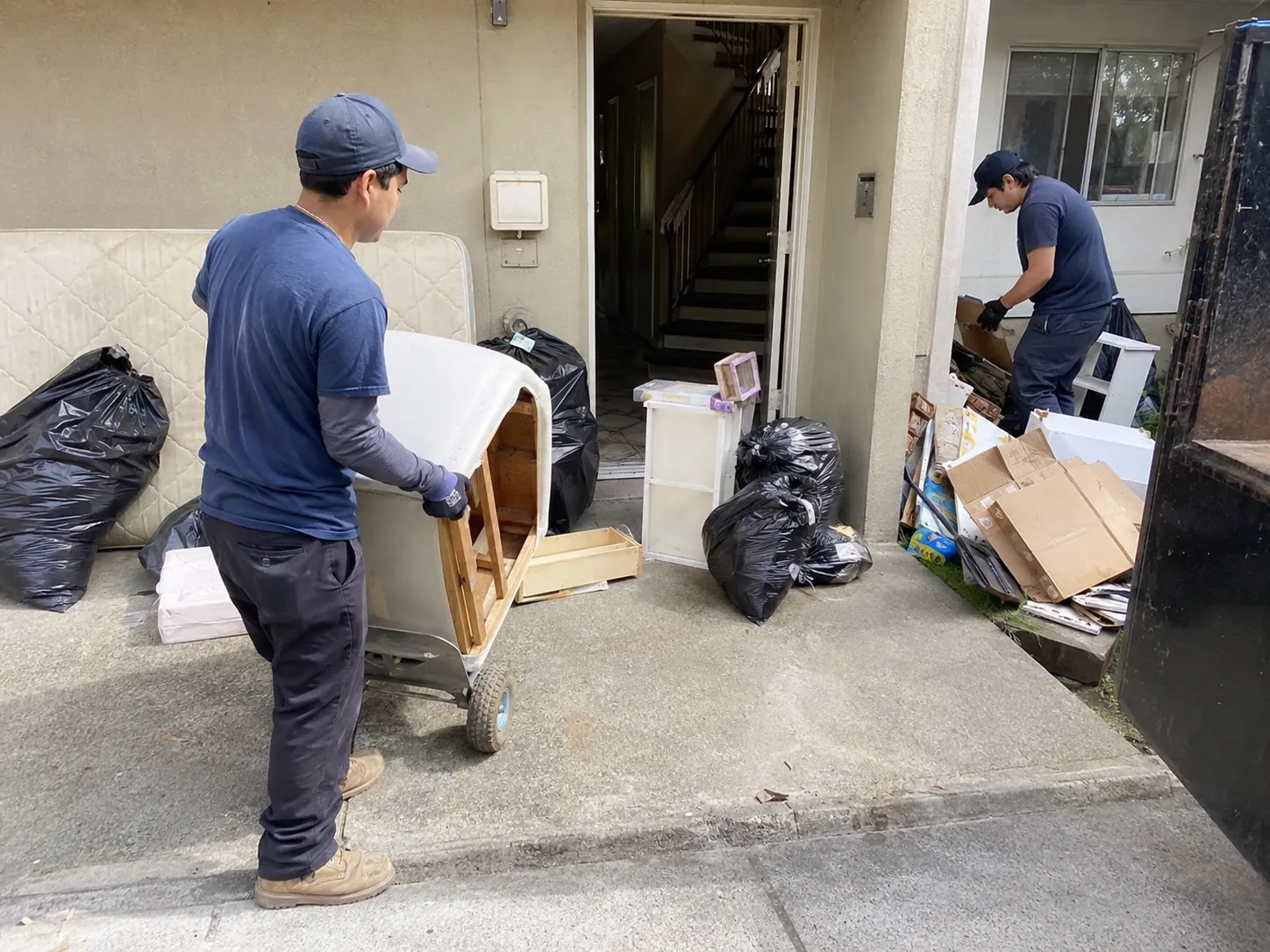 Junk removal crew clearing a rental unit for an Oakland property manager